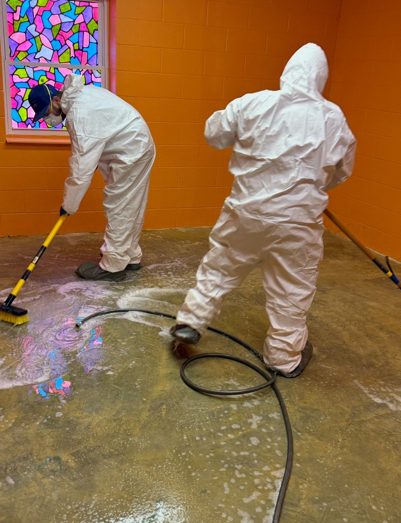OSHA-certified biohazard cleanup team in full PPE performing discreet sewage and trauma scene remediation in Houston TX